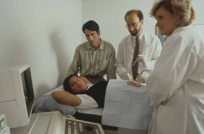 David Hyman, MD performing an amniocentesis; Denise Connor ultrasound technician.